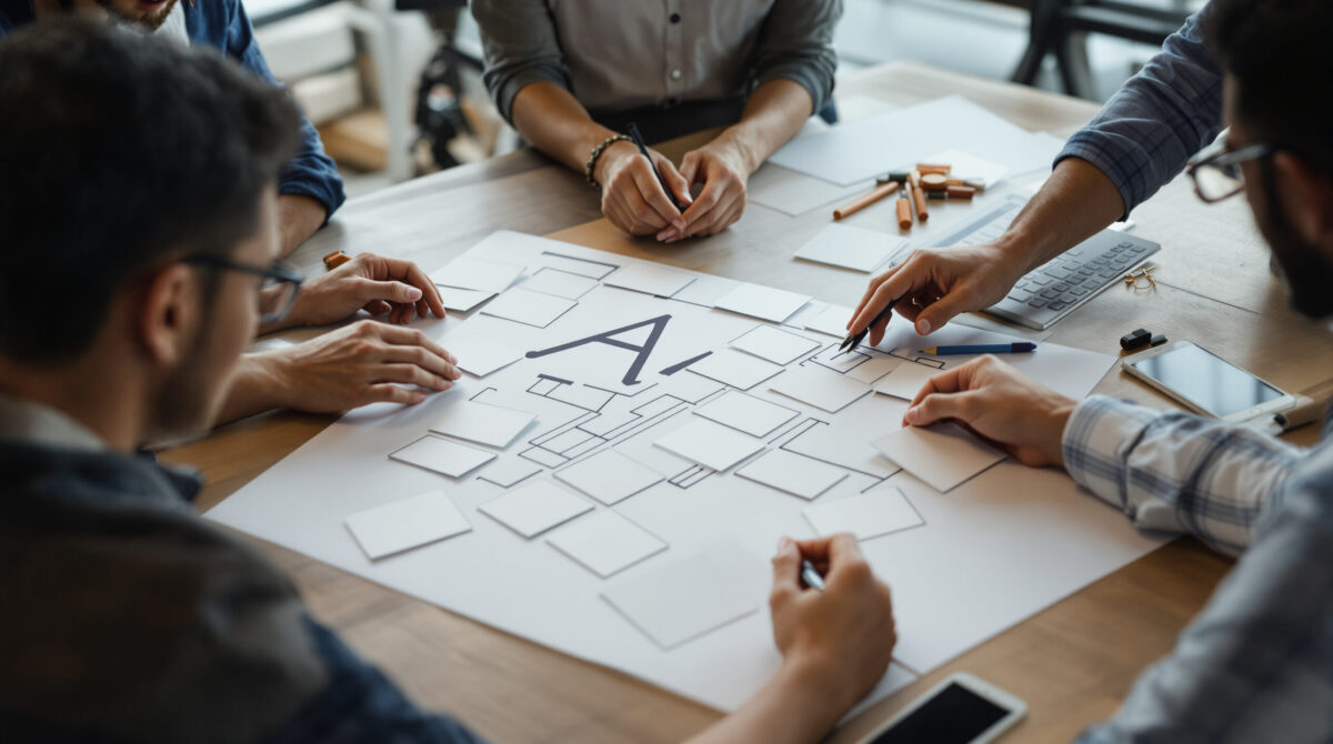 Founders mapping an AI product workflow in a workshop