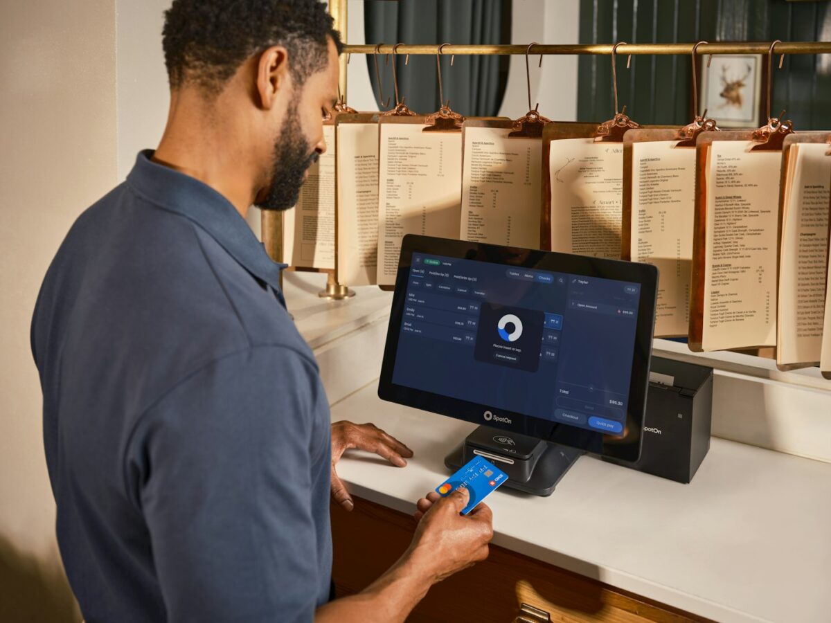 Man paying with credit card at a terminal