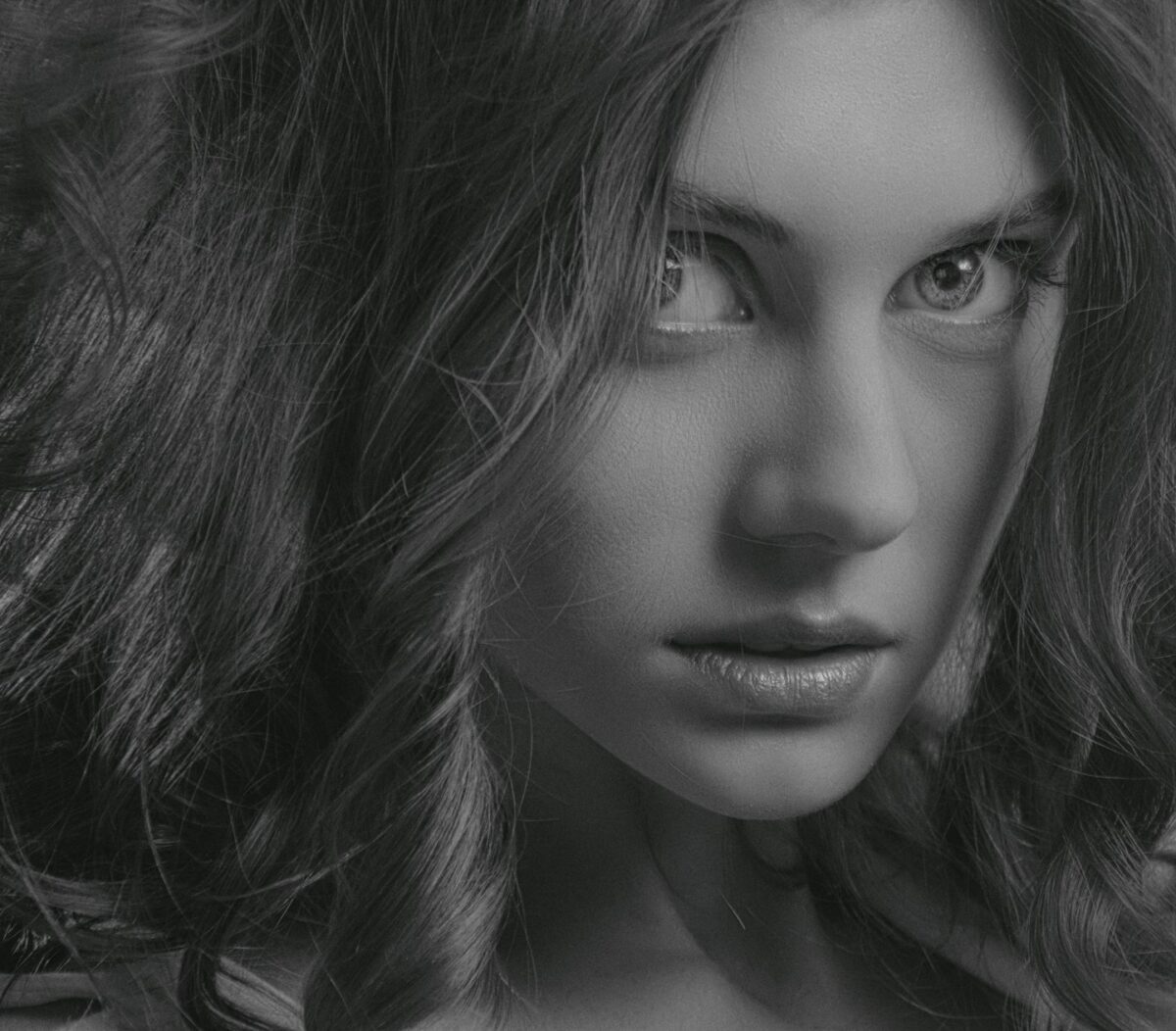 a black and white photo of a woman with long hair