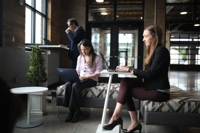 Gym owner reviewing local search results and lead inquiries on a laptop for gym SEO strategy.