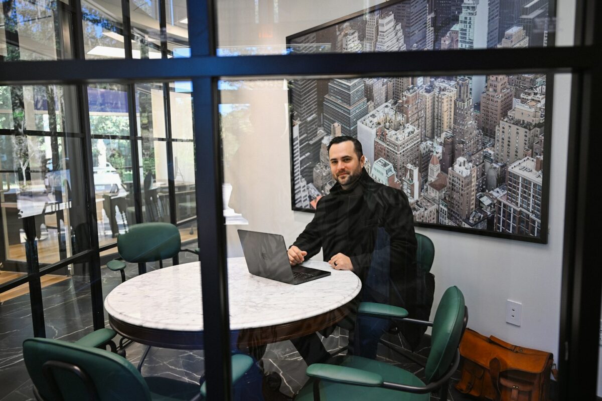 Man working on laptop in a modern office meeting room