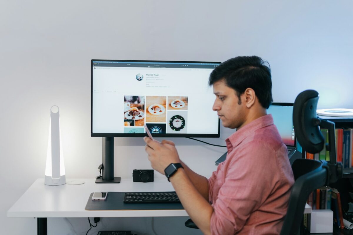 a man sitting at a desk looking at a screen